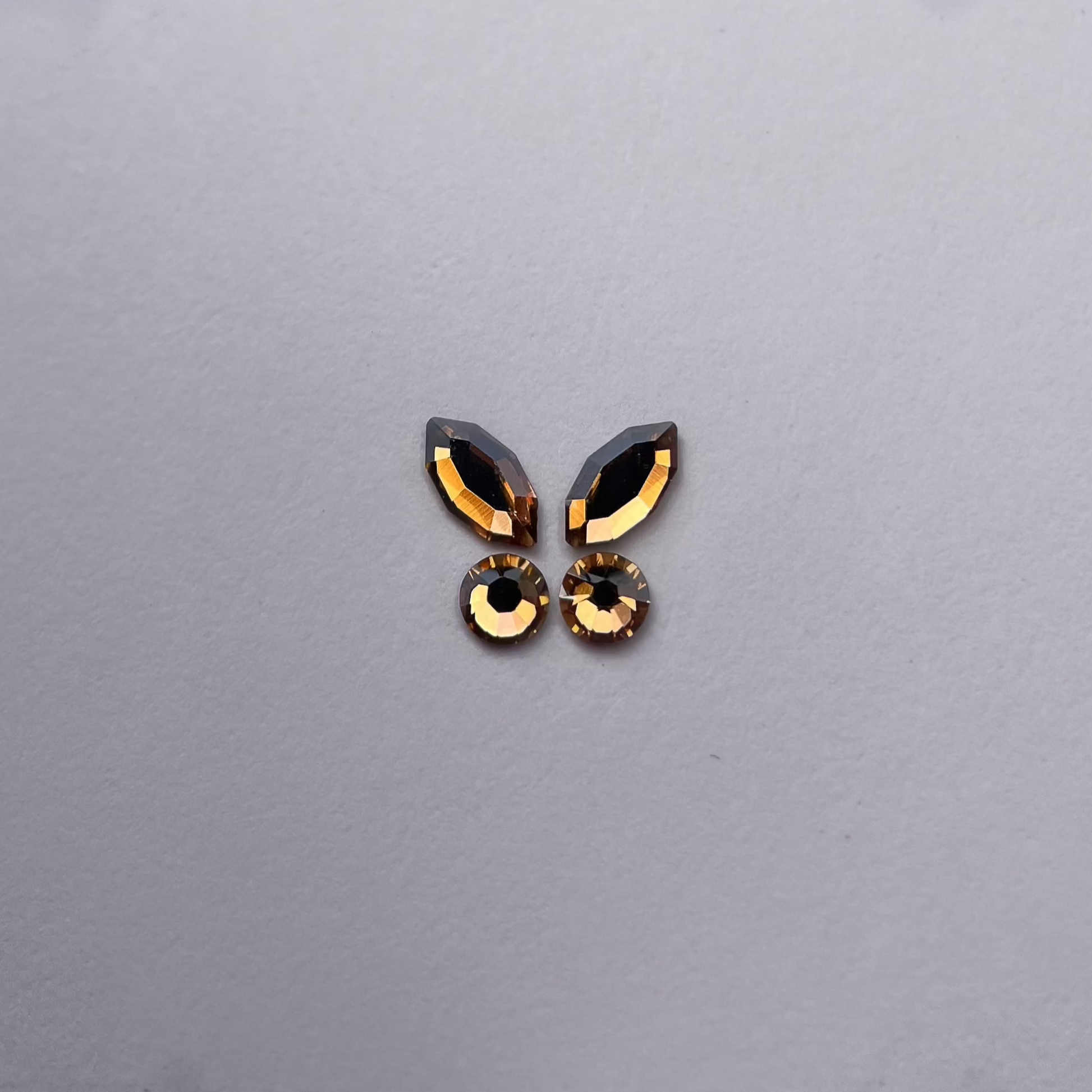 Papillon formé de deux navettes champagne et deux strass ronds coordonnés.